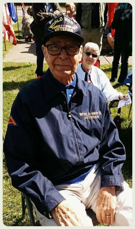 Man sitting on chair on lawn, smiling