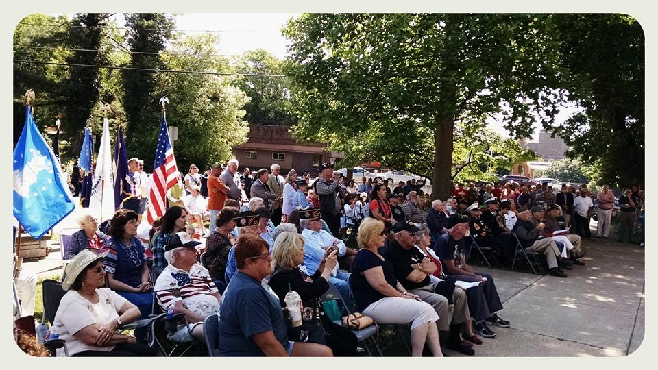 Crowd sitting on lawn chairs