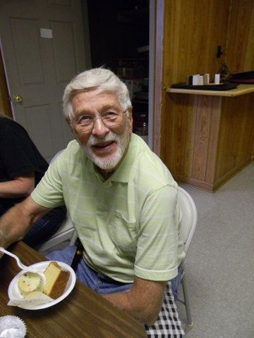 Man sitting, smiling, with cake