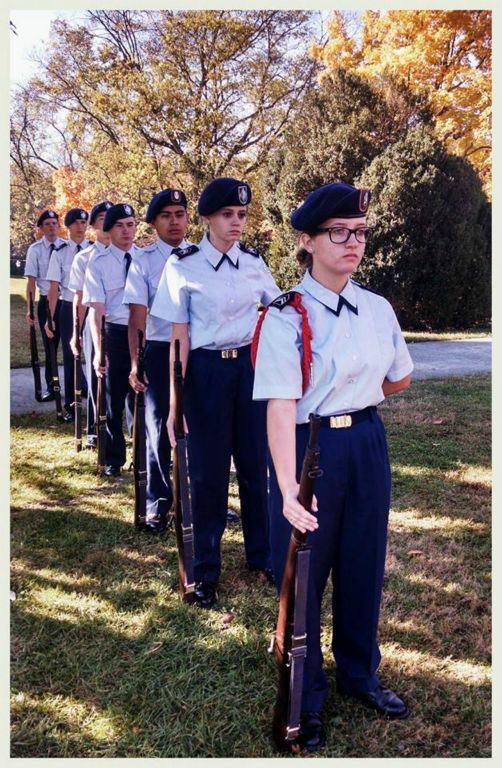 Line of cadets with firearms by their side at ease