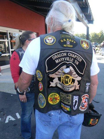 Image of back of biker vest with navy patches, POW-MIA patches