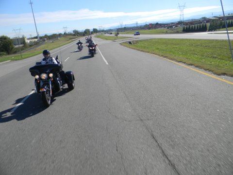 Image taken from motorcycle of motorcycles driving on road with grass on sides