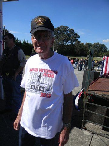 Man in white United Veterans Ride t-shirt, smiling into camera