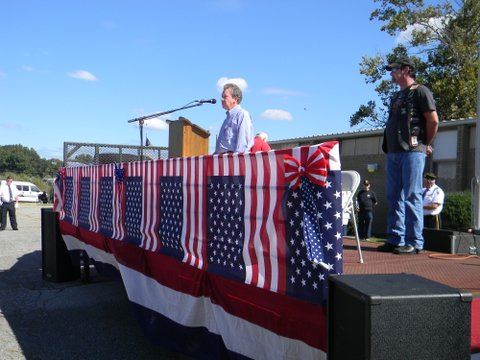 Man in blue speaking at podium