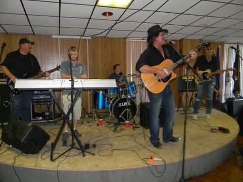 Band with drums, two guitars, a bass, and keyboard play